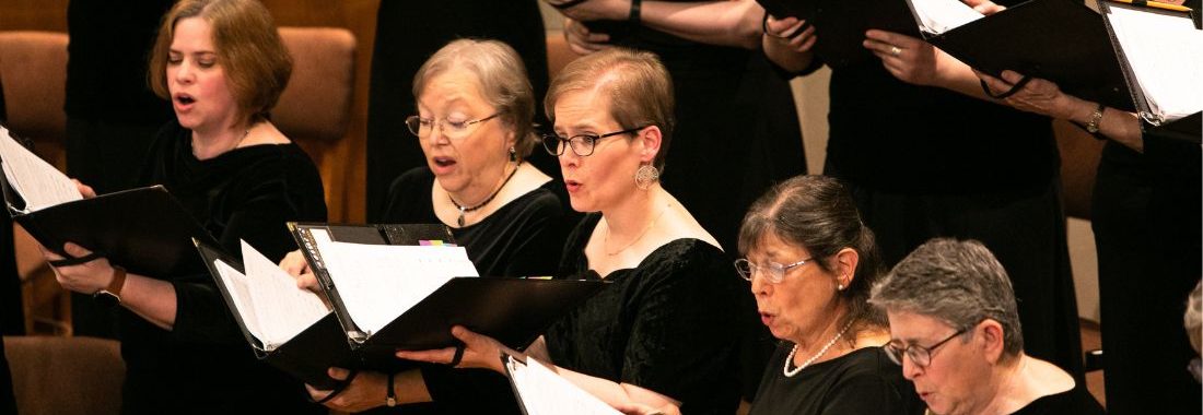 Seattle Choral Company singers in concert with scores open